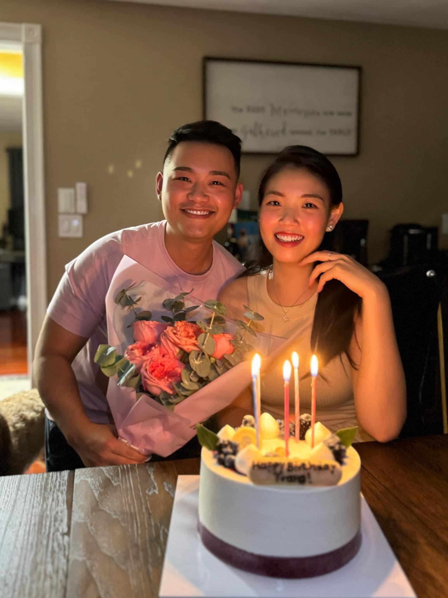 Hung and Trang celebrating with birthday cake and flowers