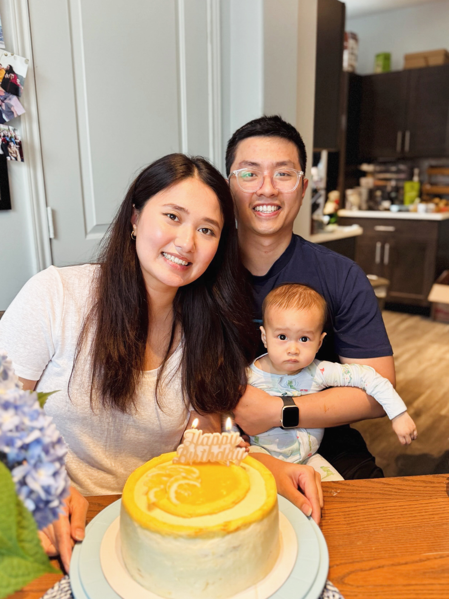 Phan, Ritu and their baby celebrating with birthday cake